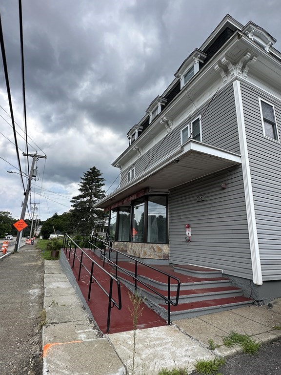 311-313 Providence Road Grafton, MA 01560 - Photo 4 of 21 a front view of a house with a small yard