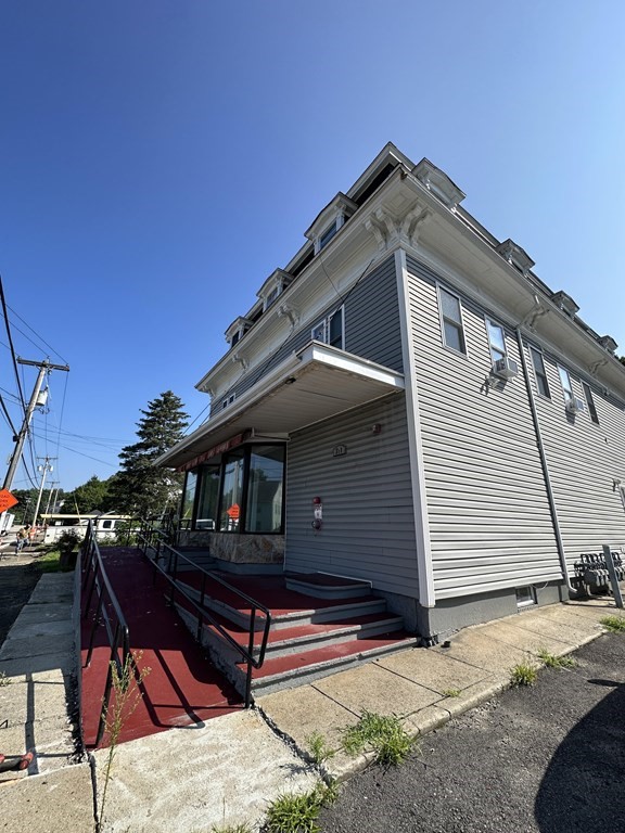 311-313 Providence Road Grafton, MA 01560 - Photo 5 of 21 a side view of a house with a wooden deck
