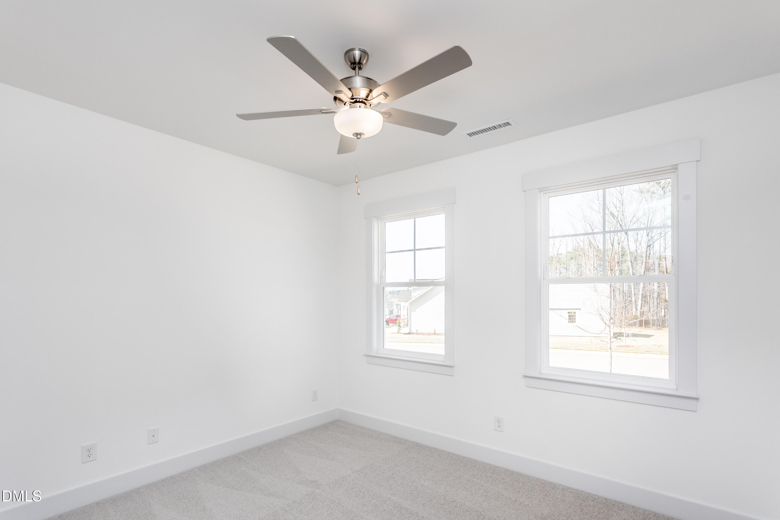 70 Slippery Elm Road Youngsville, NC 27596 - Photo 20 of 32 an empty room with windows and fan
