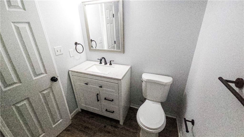 5582 Windwood Road Atlanta, GA 30349 - Photo 18 of 29 a bathroom with a toilet sink and mirror