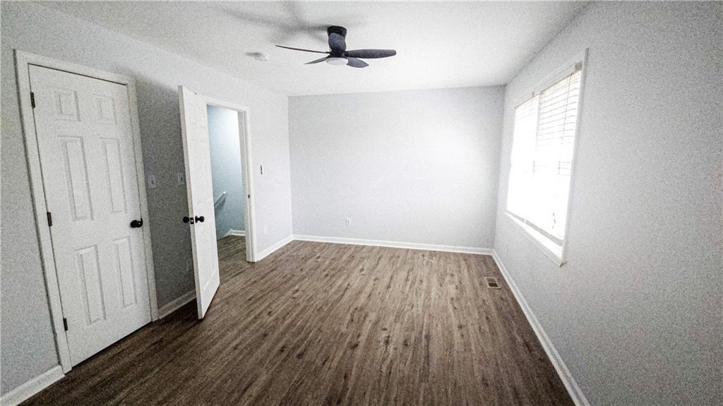 5582 Windwood Road Atlanta, GA 30349 - Photo 19 of 29 wooden floor in an empty room with a window