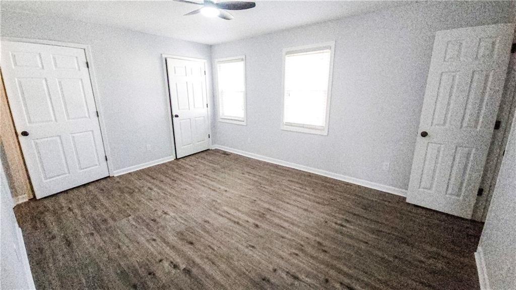 5582 Windwood Road Atlanta, GA 30349 - Photo 20 of 29 an empty room with wooden floor and windows