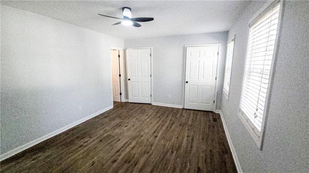 5582 Windwood Road Atlanta, GA 30349 - Photo 21 of 29 a view of empty room with wooden floor and fan