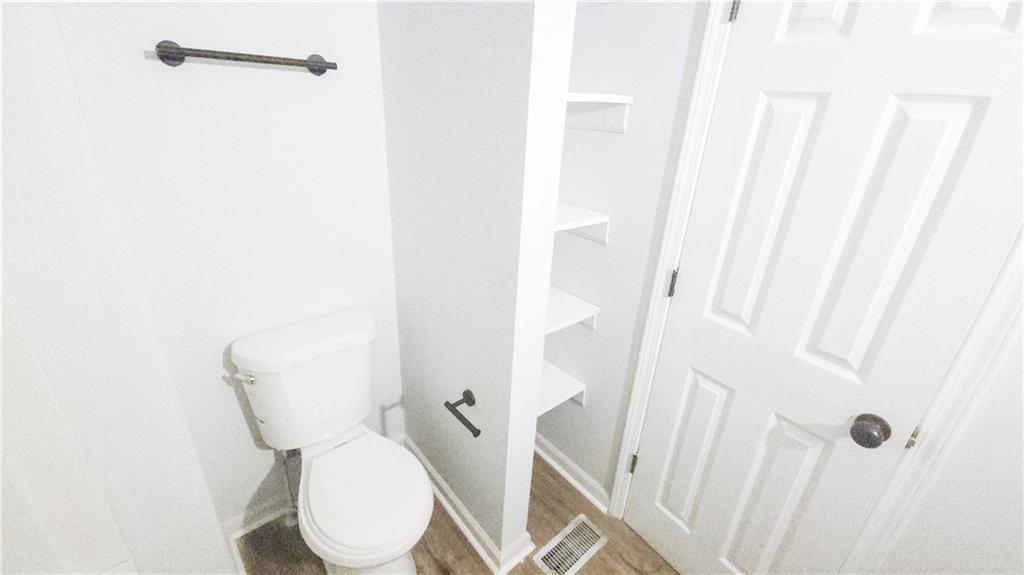 5582 Windwood Road Atlanta, GA 30349 - Photo 24 of 29 a bathroom with a toilet and sink