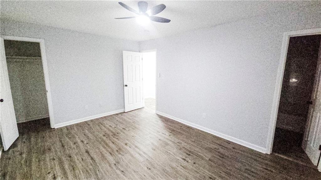 5582 Windwood Road Atlanta, GA 30349 - Photo 25 of 29 an empty room with wooden floor and fan
