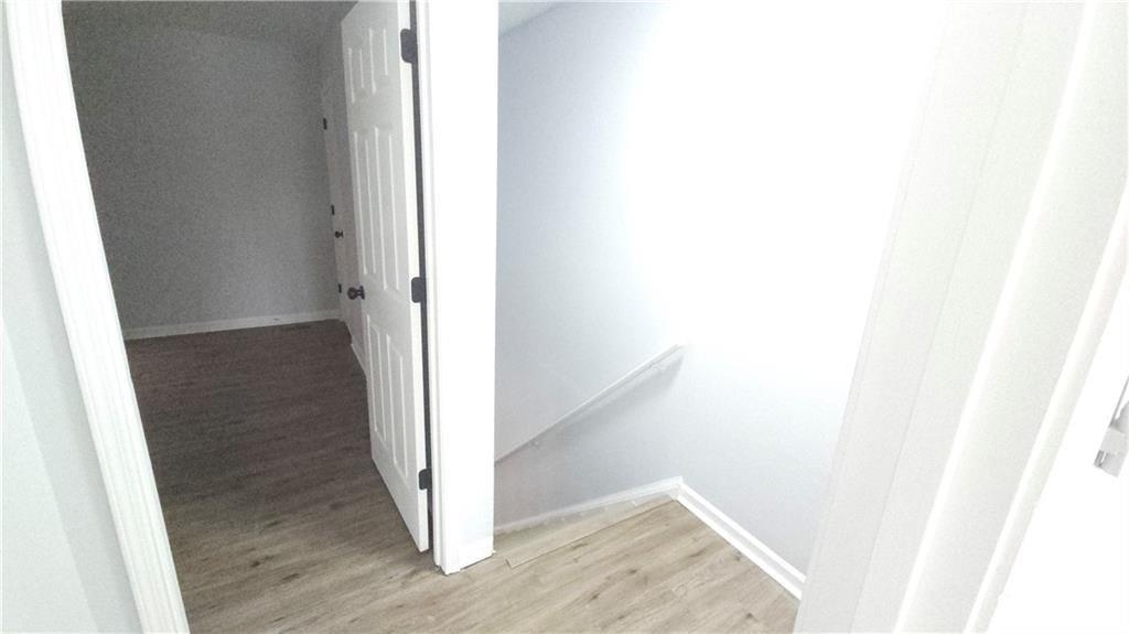 5582 Windwood Road Atlanta, GA 30349 - Photo 26 of 29 a view of a hallway with wooden floor
