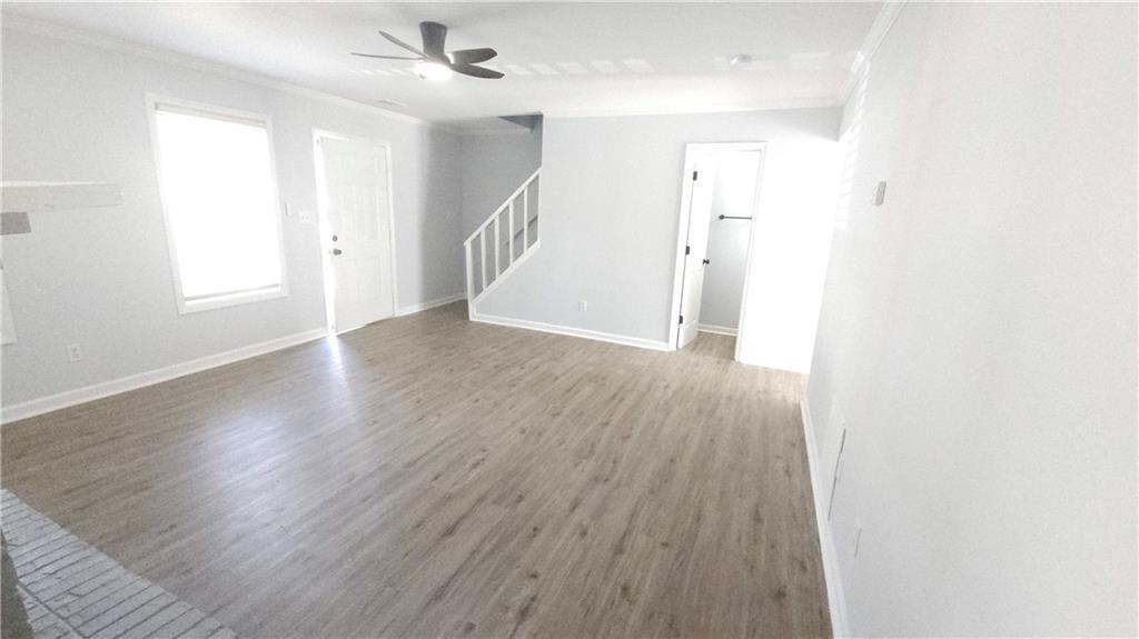 5582 Windwood Road Atlanta, GA 30349 - Photo 28 of 29 an empty room with wooden floor and windows