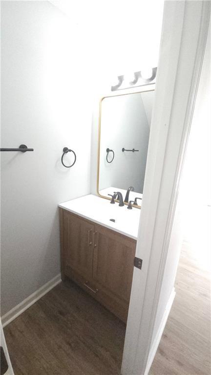 5582 Windwood Road Atlanta, GA 30349 - Photo 29 of 29 a bathroom with a sink and mirror