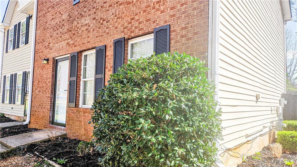 5582 Windwood Road Atlanta, GA 30349 - Photo 4 of 29 a view of a brick house with plants