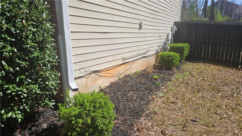 5582 Windwood Road Atlanta, GA 30349 - Photo 5 of 29 a view of a backyard with plants and wooden fence