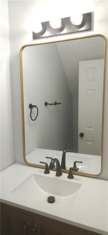 5582 Windwood Road Atlanta, GA 30349 - Photo 7 of 29 a bathroom with a sink and a mirror