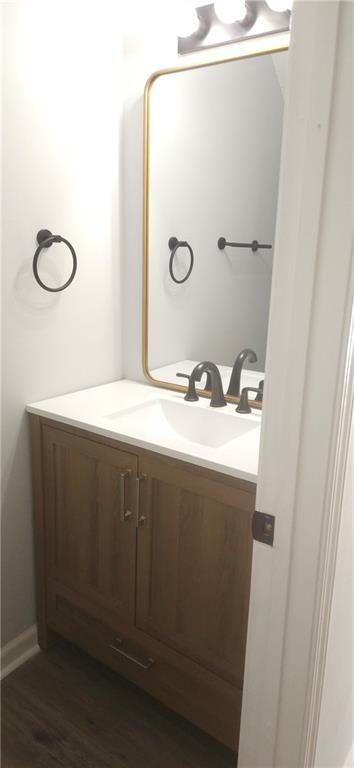 5582 Windwood Road Atlanta, GA 30349 - Photo 8 of 29 a bathroom with a sink vanity and mirror