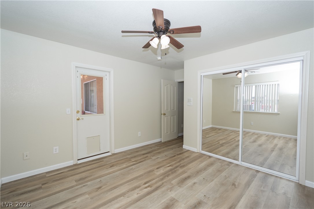2381 Tough Boy Road Pahrump, NV 89060 - Photo 23 of 44 This spacious bedroom features warm wood flooring and a refreshing ceiling fan for ultimate comfort.