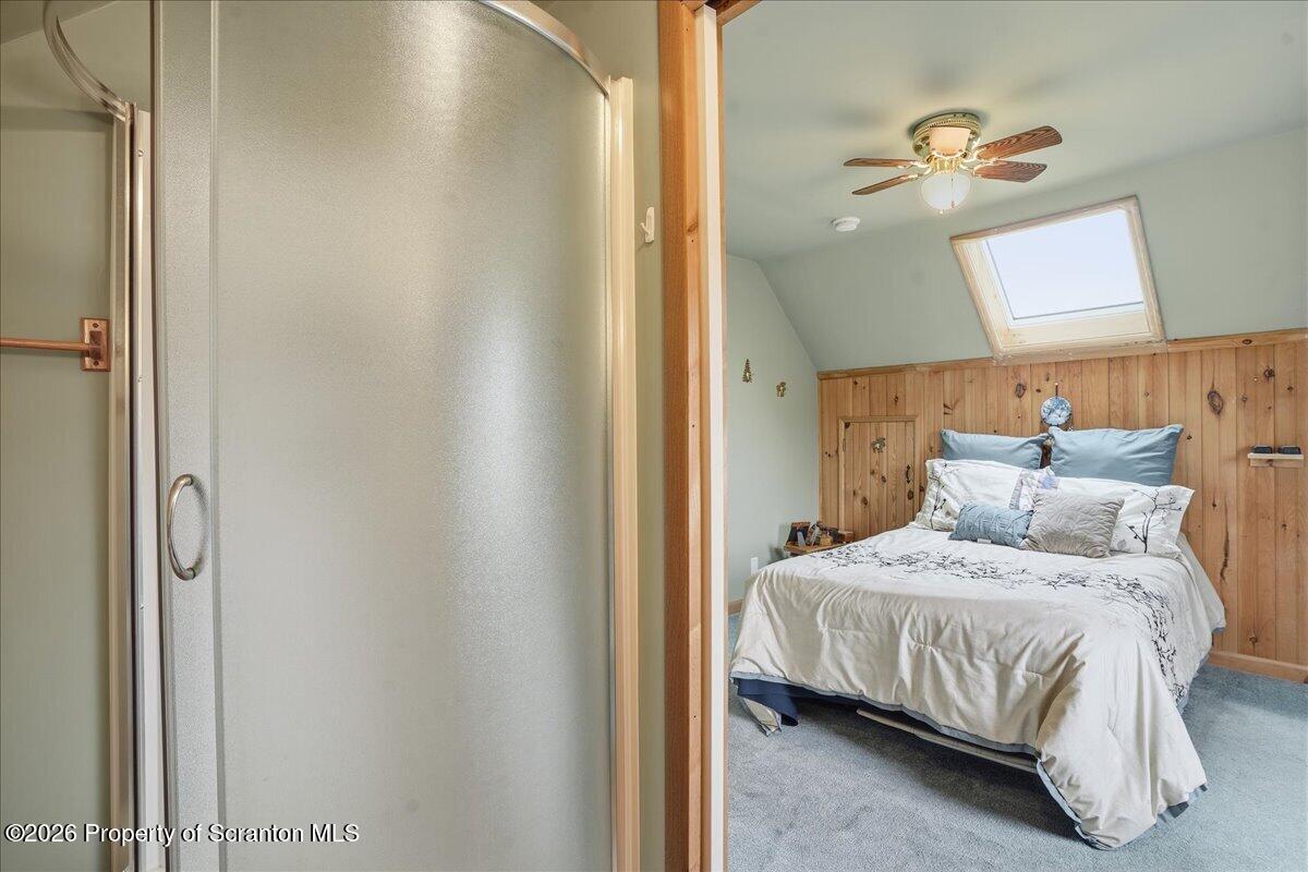 5231 Fiddle Lake Road Thompson, PA 18465 - Photo 19 of 34 a bedroom with a bed and a mirror