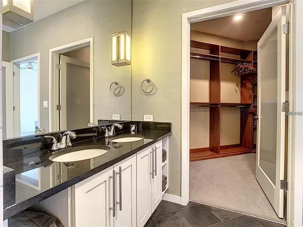 a bathroom with a double vanity sink and mirror