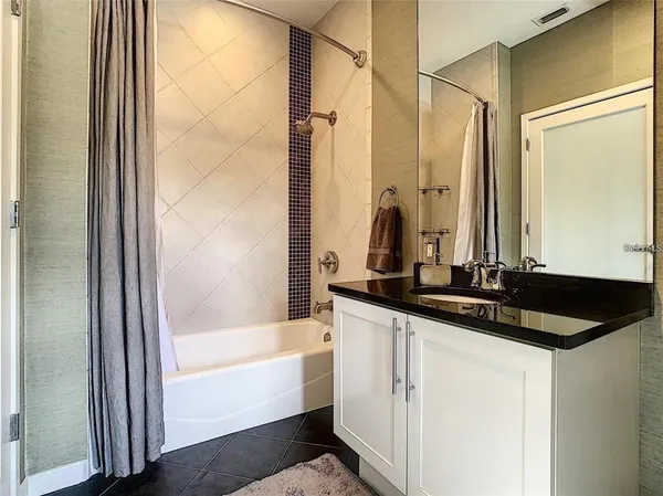 a bathroom with a bathtub and a sink