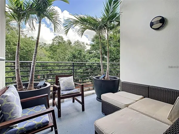 a balcony with view of outdoor space and seating