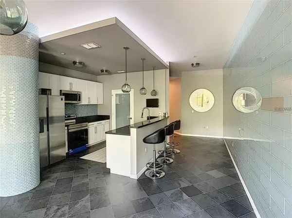 a kitchen with stainless steel appliances kitchen island granite countertop a sink and a stove