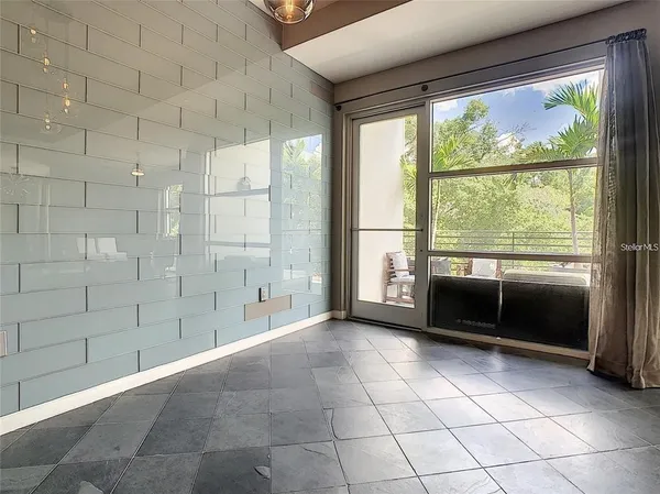 a view of an empty room with a fireplace and a shower