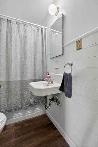 a bathroom with a sink toilet and shower