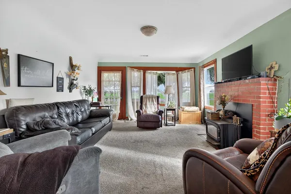 a living room with furniture fireplace and flat screen tv
