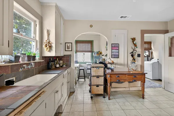 a large white kitchen with a window