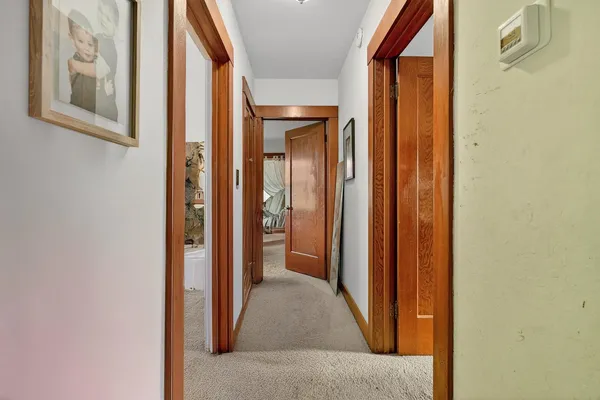 a view of a hallway with wooden floor and entryway