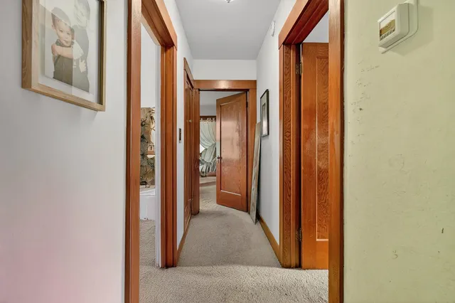 a view of a hallway with wooden floor and entryway