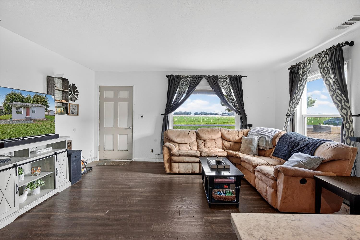 28015 Blossom Road Thornton, CA 95686 - Photo 4 of 34 a living room with furniture and a wooden floor