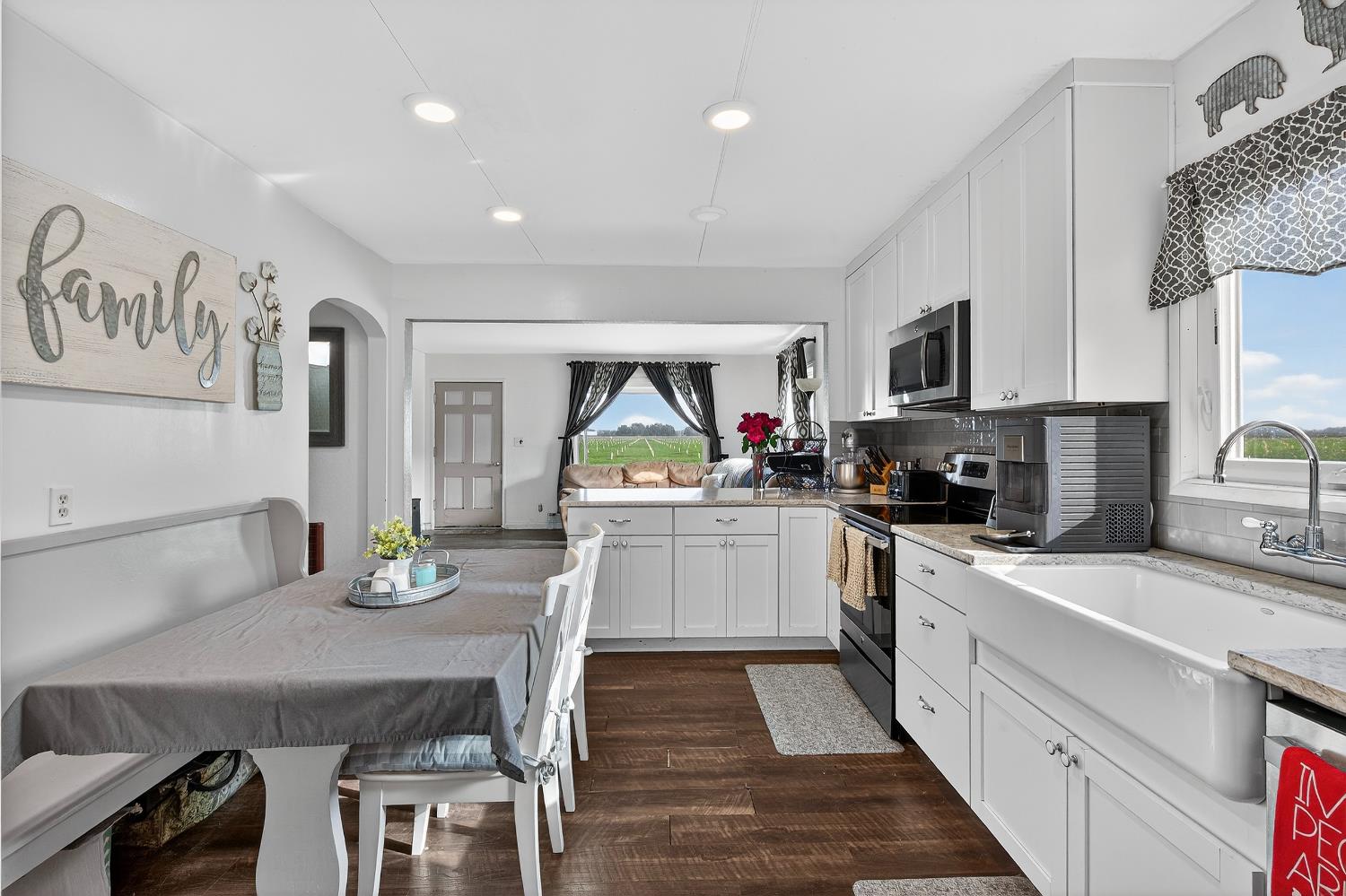 28015 Blossom Road Thornton, CA 95686 - Photo 7 of 34 a kitchen with white cabinets stainless steel appliances and sink