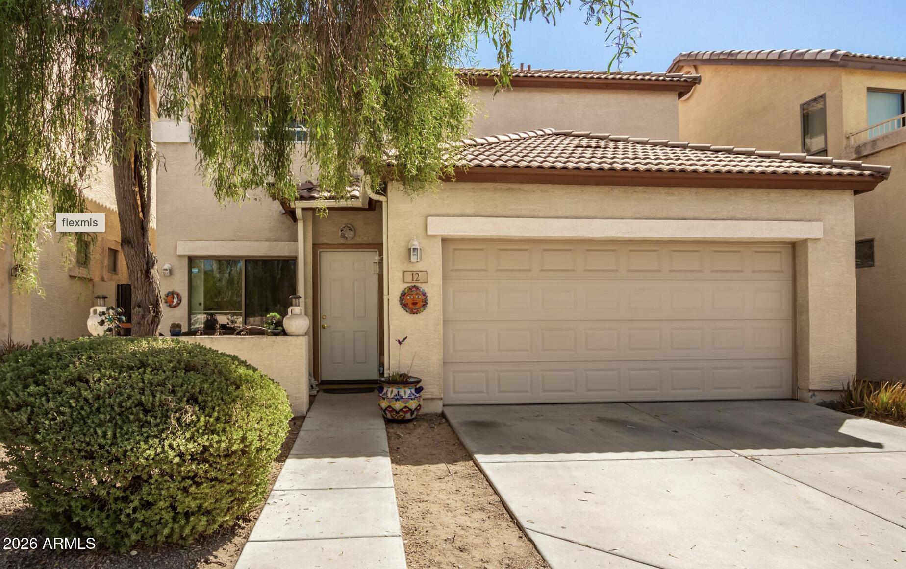 10225 West Camelback Road, Unit 12 Phoenix, AZ 85037 - Photo 1 of 19 a front view of a house