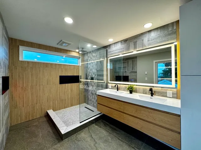 a bathroom with a double vanity sink and a mirror
