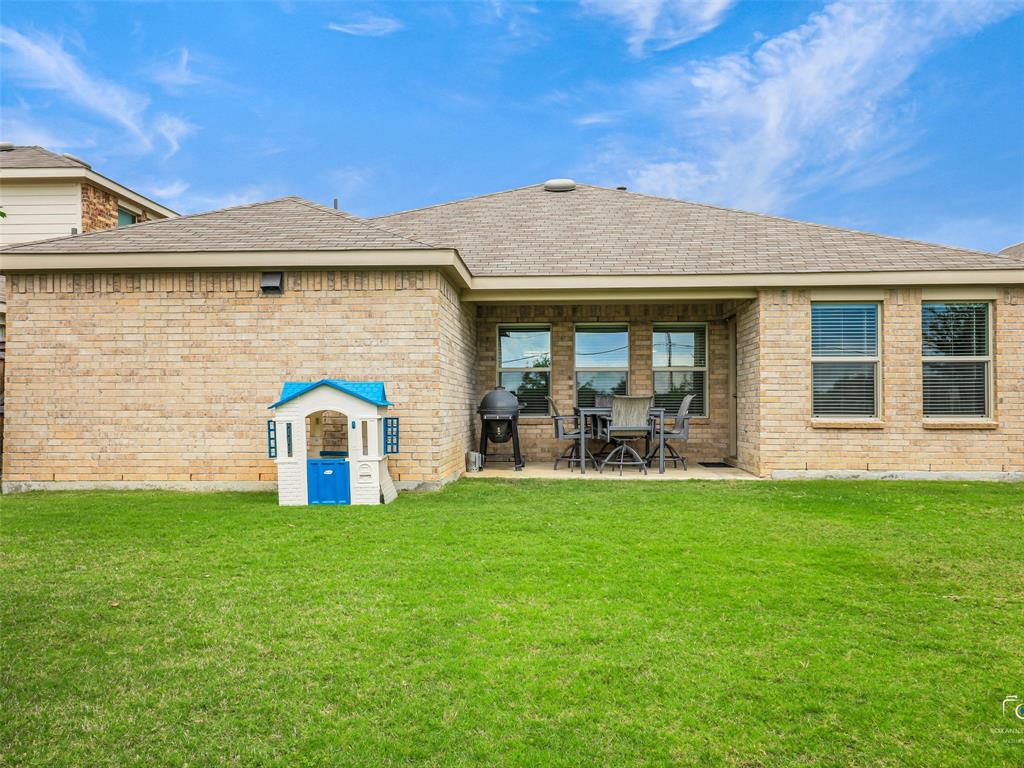 4517 Ashmark Road Aubrey, TX 76227 - Photo 25 of 26 a view of a house with a yard and sitting area
