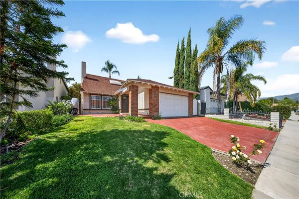 a view of a house with a swimming pool and a yard