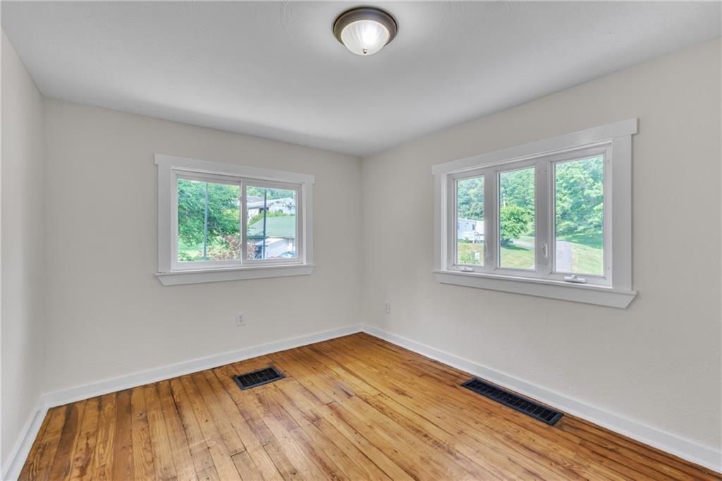 116 Purvis Lane Valencia, PA 16059 - Photo 6 of 49 an empty room with wooden floor and windows