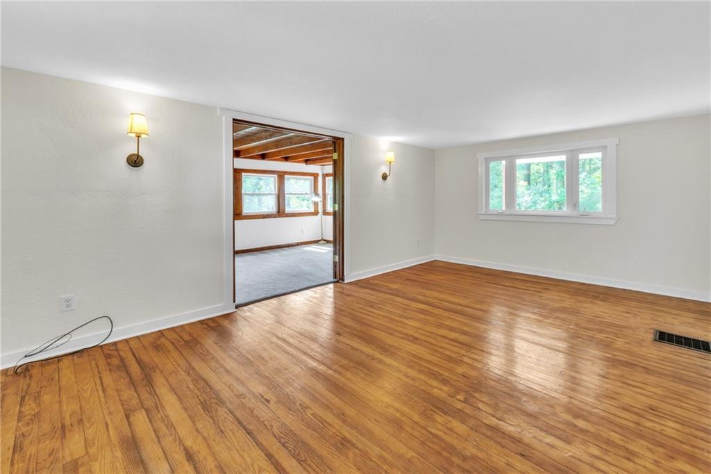 116 Purvis Lane Valencia, PA 16059 - Photo 7 of 49 an empty room with wooden floor and windows