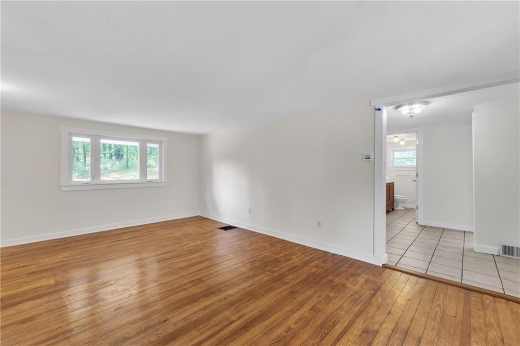116 Purvis Lane Valencia, PA 16059 - Photo 8 of 49 an empty room with wooden floor and windows