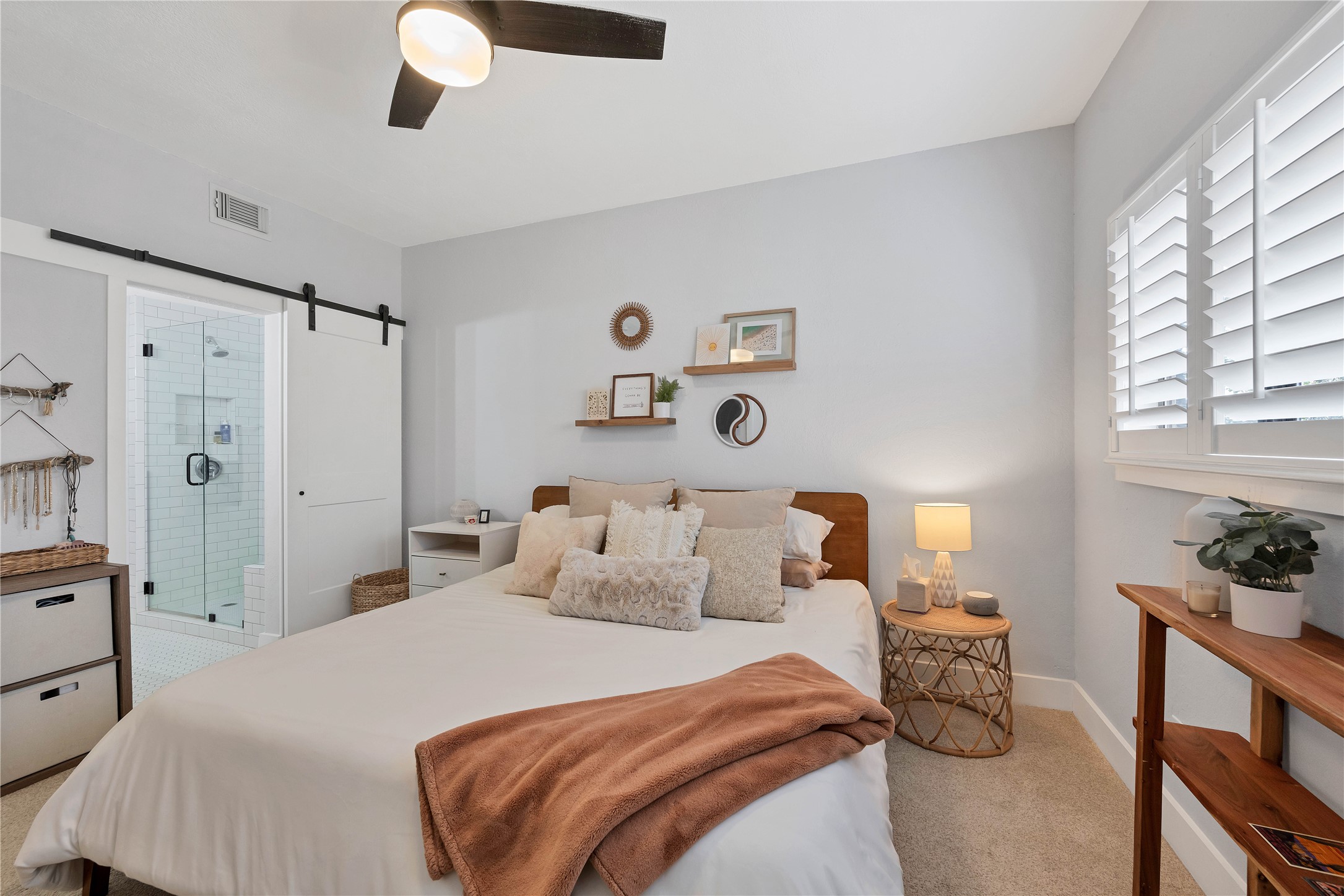 2605 Enfield Road, Unit 221 Austin, TX 78703 - Photo 5 of 30 Bedroom 1 with ensuite bathroom and sliding barn door easily accommodates a king-size bed.