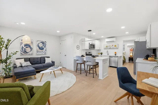 a living room with furniture and kitchen view