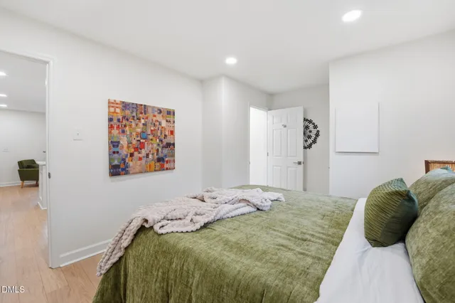 a bed sitting in a bedroom next to a window