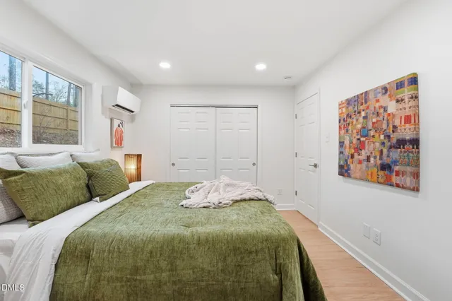 a bedroom with a large bed and a window