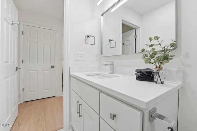 a bathroom with a sink a vanity and a mirror