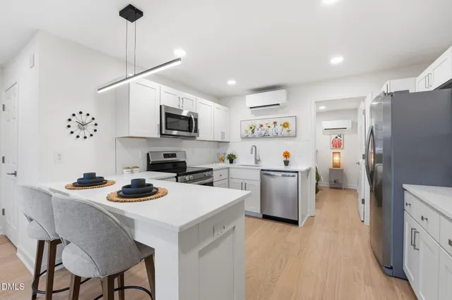 a kitchen with a refrigerator a stove top oven a sink dishwasher and a refrigerator