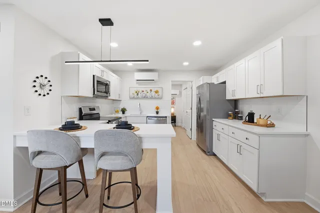a kitchen with stainless steel appliances granite countertop a sink and cabinets