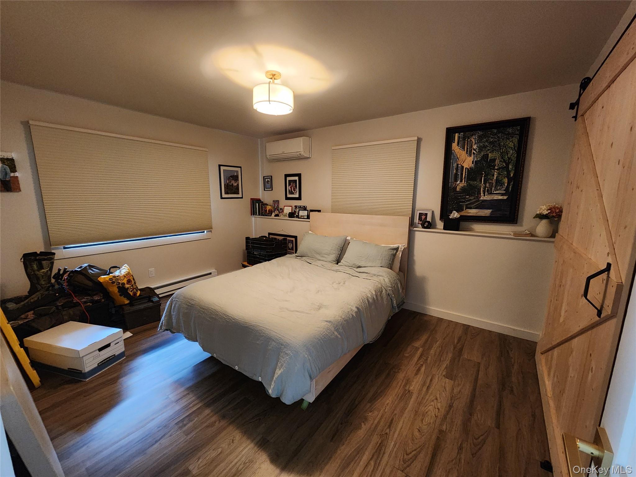53 Lake Pleasant Road Staatsburg, NY 12580 - Photo 23 of 34 a bedroom with a bed and a dresser with wooden floor