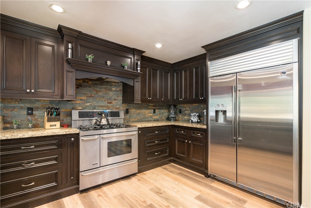 a kitchen with a sink a stove and cabinets