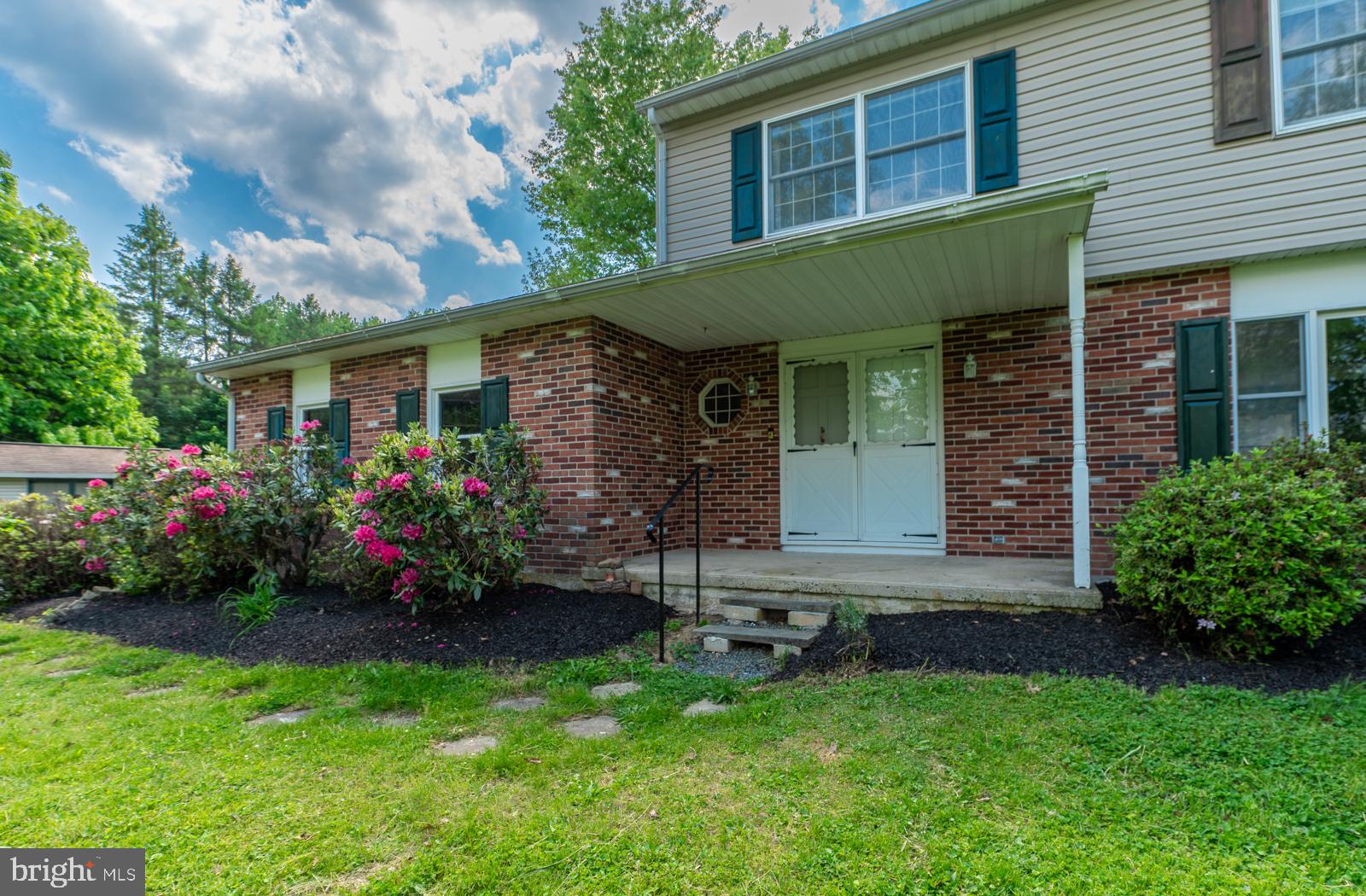223 Trythall Road Elverson, PA 19520 - Photo 3 of 78 a front view of a house with a garden