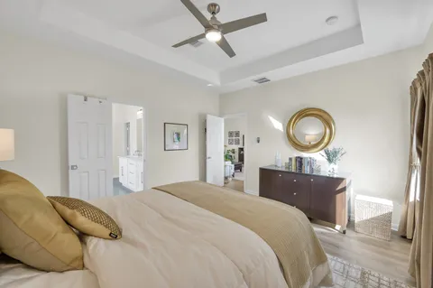 a bedroom with a bed and a lamp
