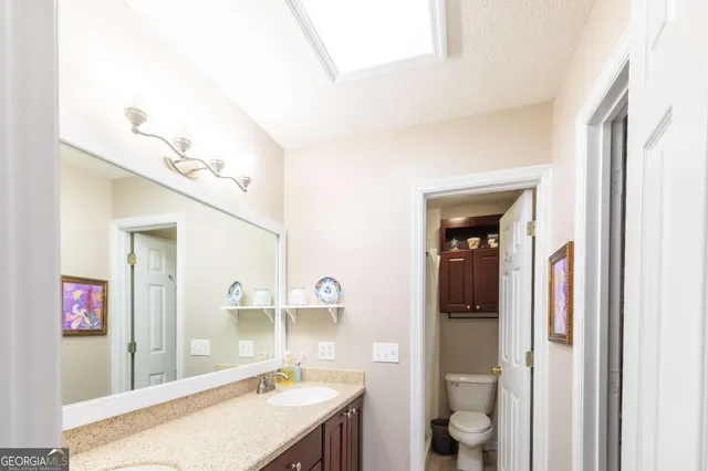 a bedroom with two beds and a chandelier