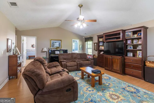a living room with furniture and a book shelf